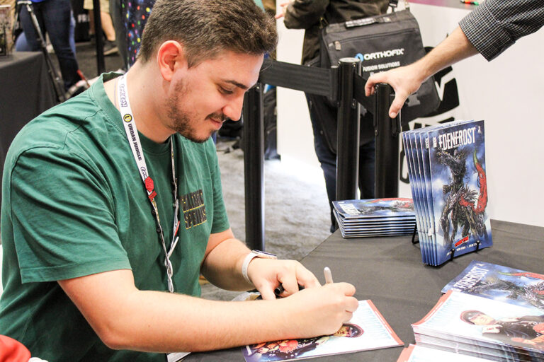 Bruno Frenda, illustrator of Edenfrost, signing our Edenfrost preview at New York Comic Con