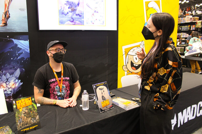 Zac Thompson and Rachel Pinnelas at the Mad Cave Studios booth at New York Comic Con 2023